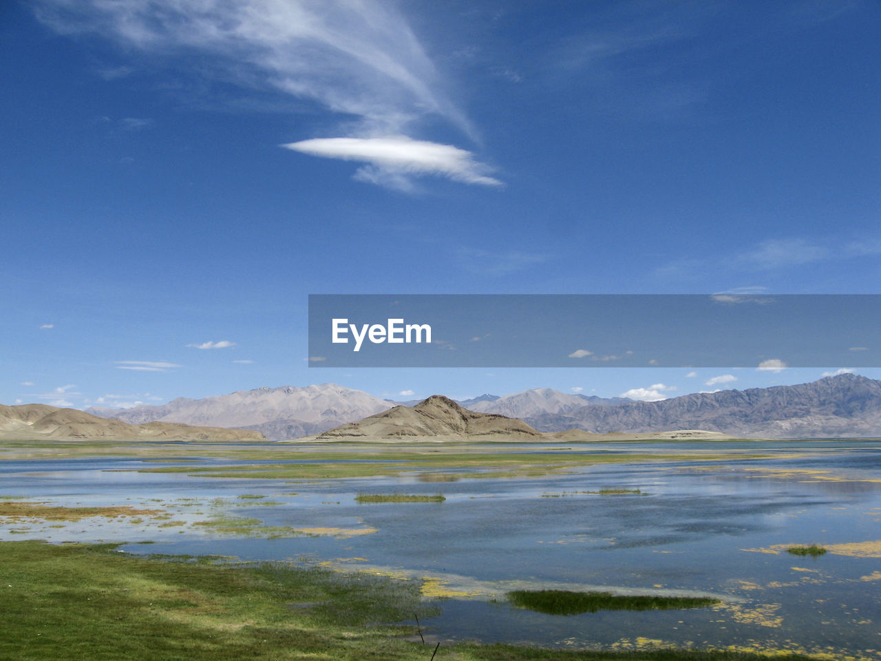 mountain, sky, scenics - nature, water, lake, environment, beauty in nature, reflection, horizon, landscape, cloud, nature, land, mountain range, no people, blue, travel destinations, tranquil scene, tranquility, travel, snow, body of water, sunlight, day, non-urban scene, outdoors, cold temperature, shore, coast, natural environment, reservoir, grass, plant, morning, winter, tourism