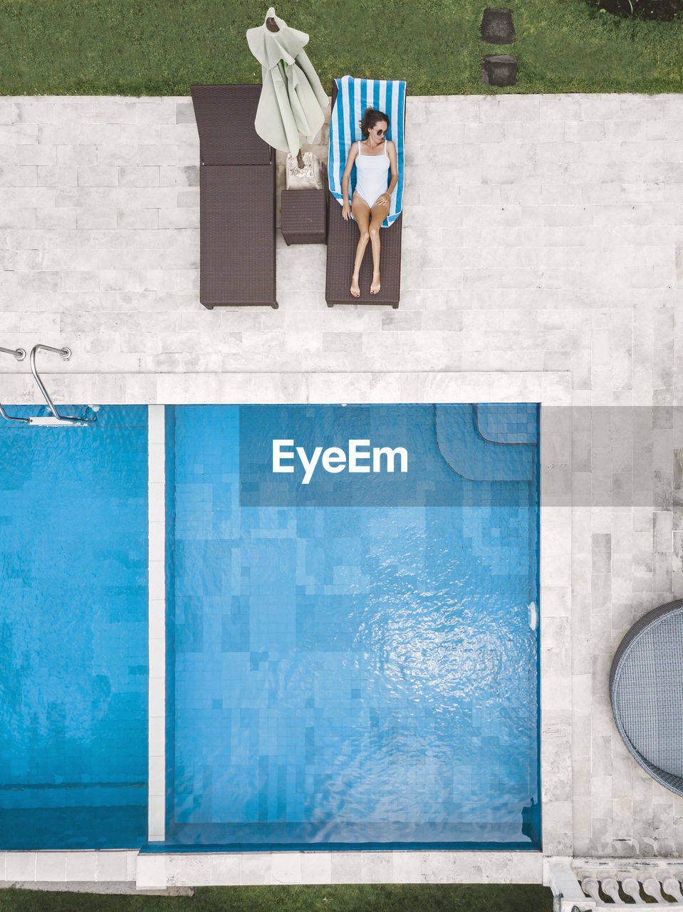 Aerial view of attractive woman near the pool at resort