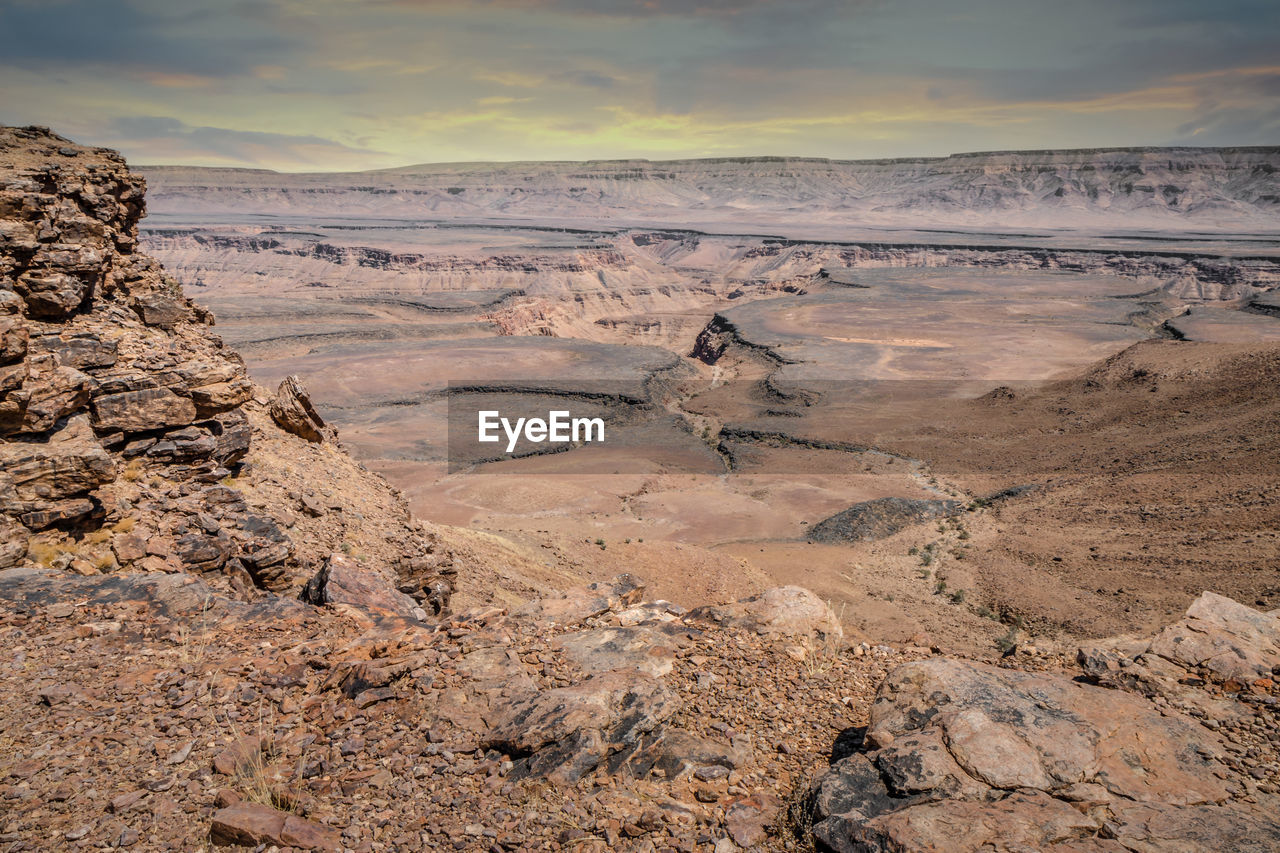 Scenic view of land against sky during sunset