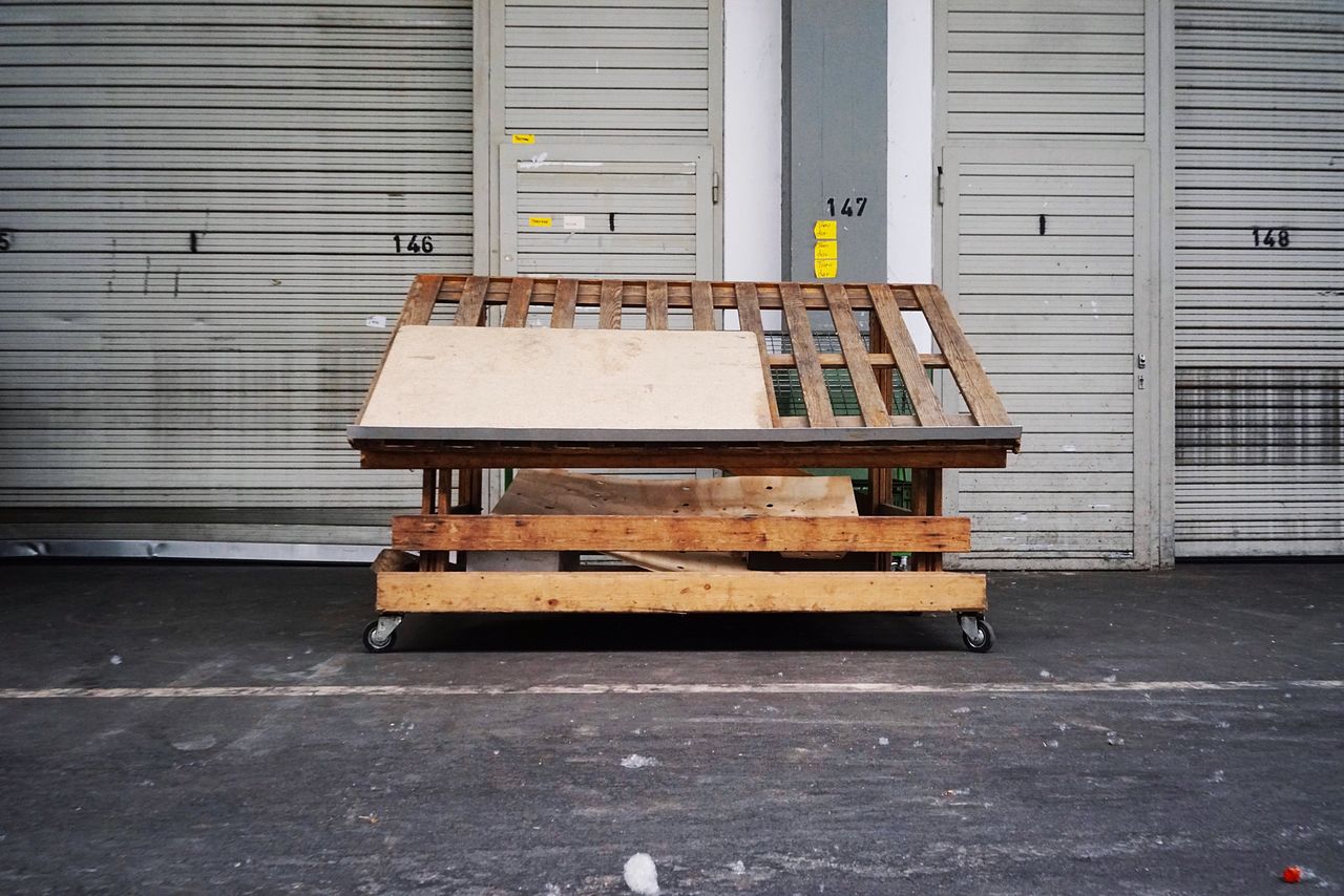 EMPTY BENCHES AGAINST BUILDING