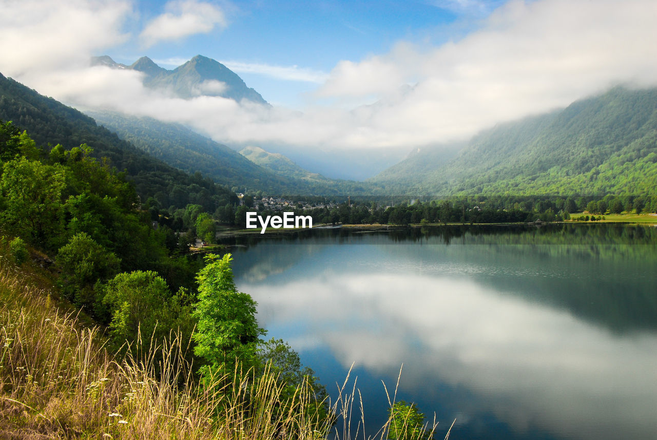 Scenic view of lake and mountains against sky