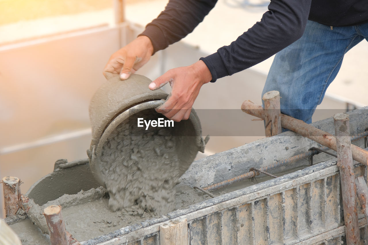 Man working pouring concrete in structure 