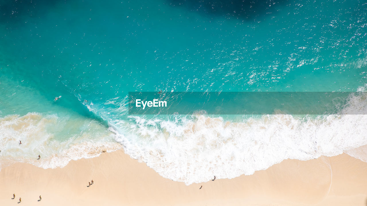 High angle view of waves rushing towards shore