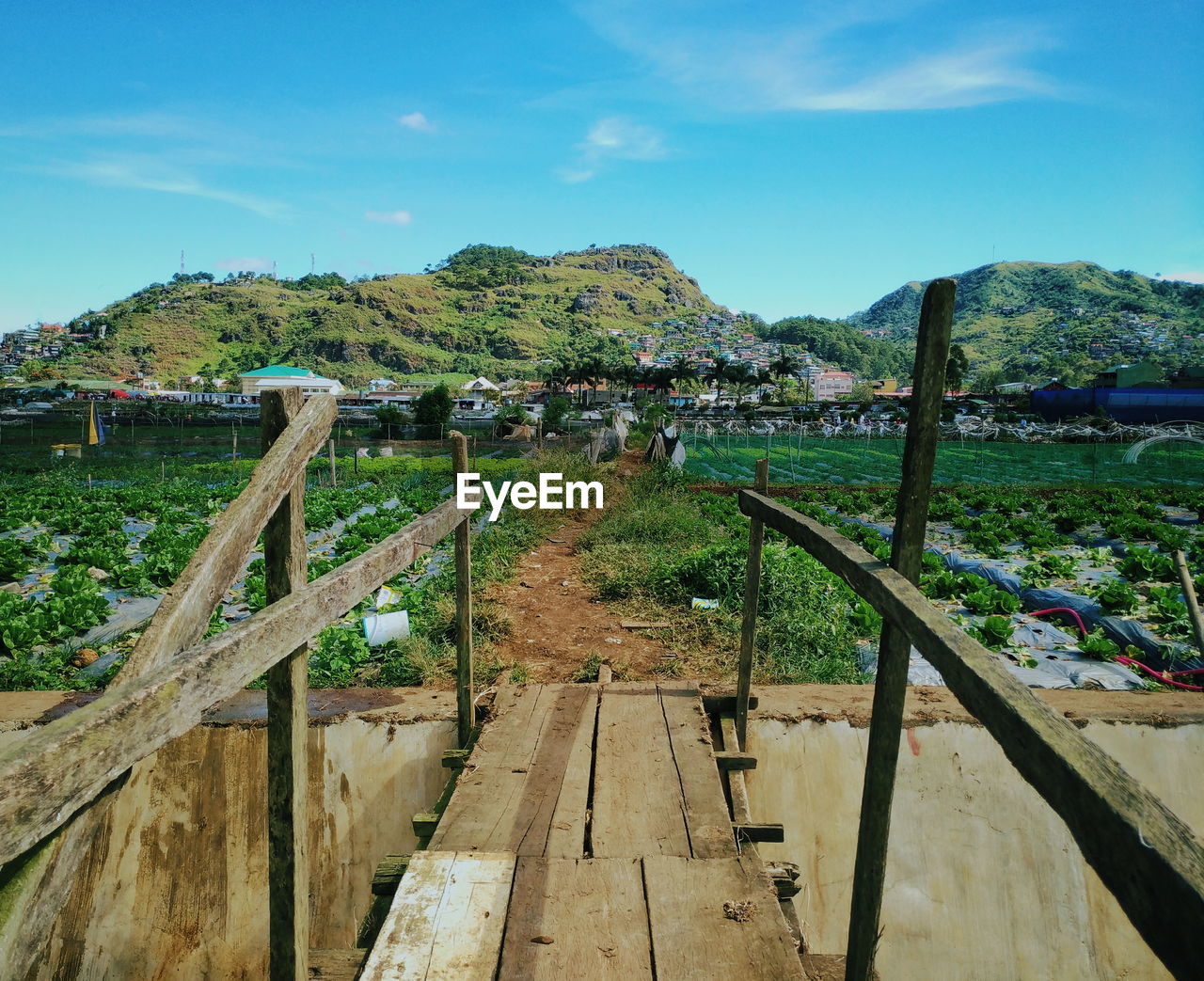 Scenic view of river by mountains against sky