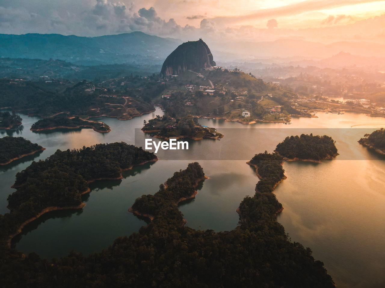 Sunset over the lakes around guatape colombia with the famous monolith.