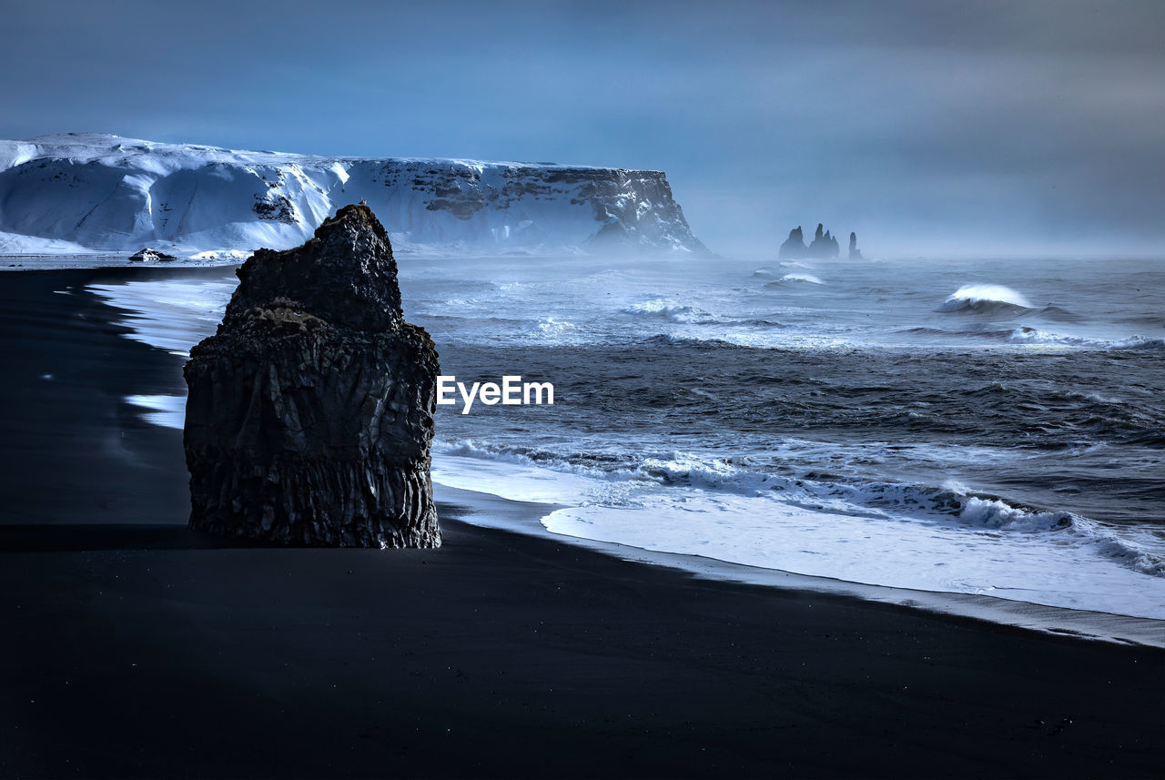 Iceland view of rocks in sea against sky
