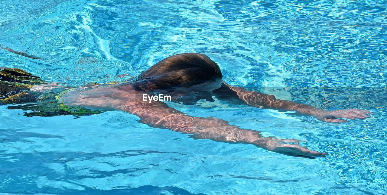 High angle view of woman swimming in pool