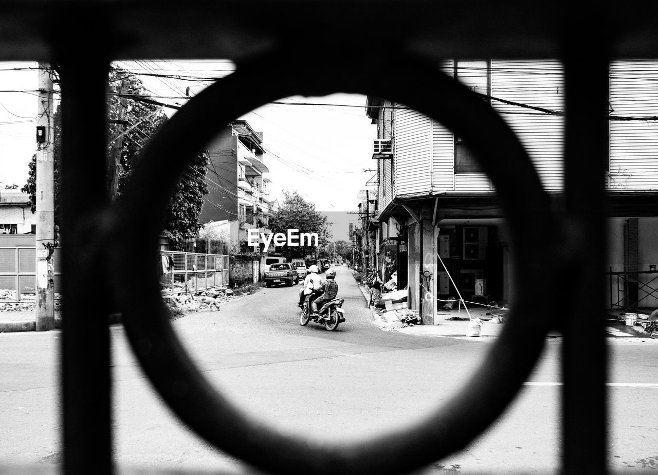 VIEW OF STREET SEEN THROUGH FENCE