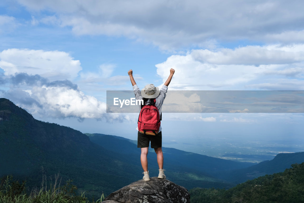 rear view of man standing on mountain