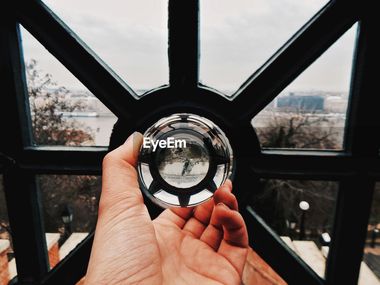 Close-up of person holding a glassball