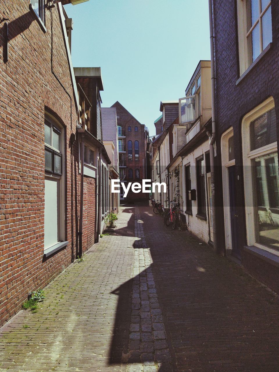 Empty alley amidst buildings in city