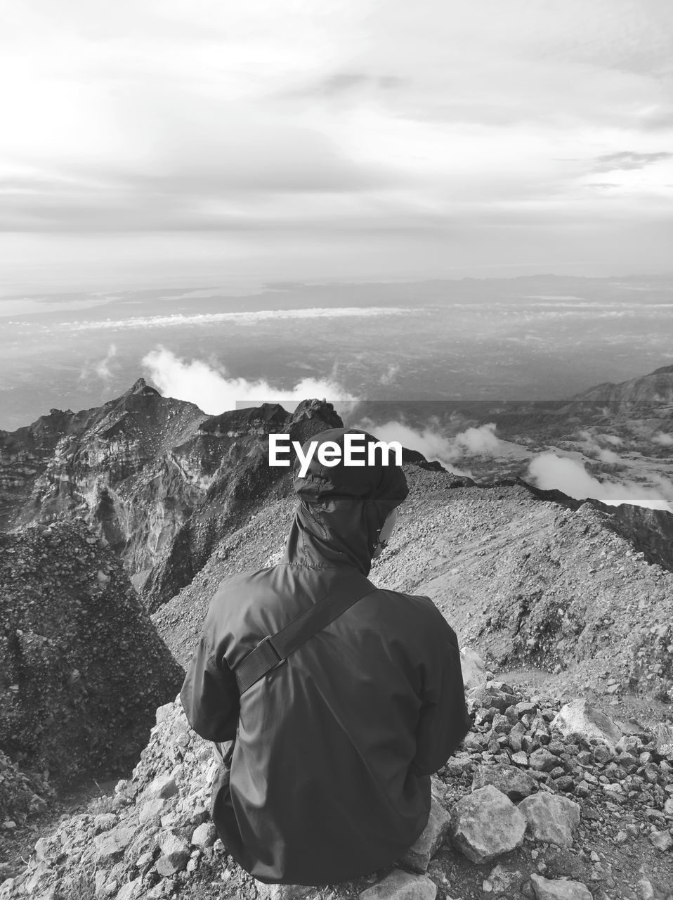 Rear view of man looking at mountain against sky