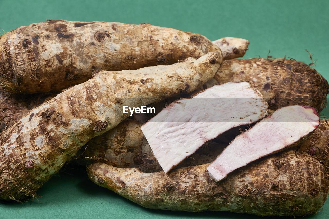 Closeup of taro root vegetable, eddo malanga, green background