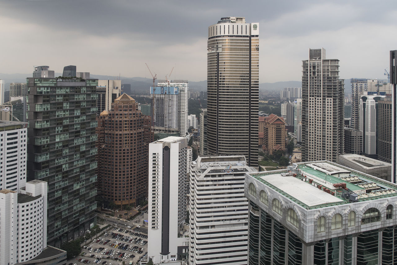 AERIAL VIEW OF BUILDINGS IN CITY AGAINST SKY