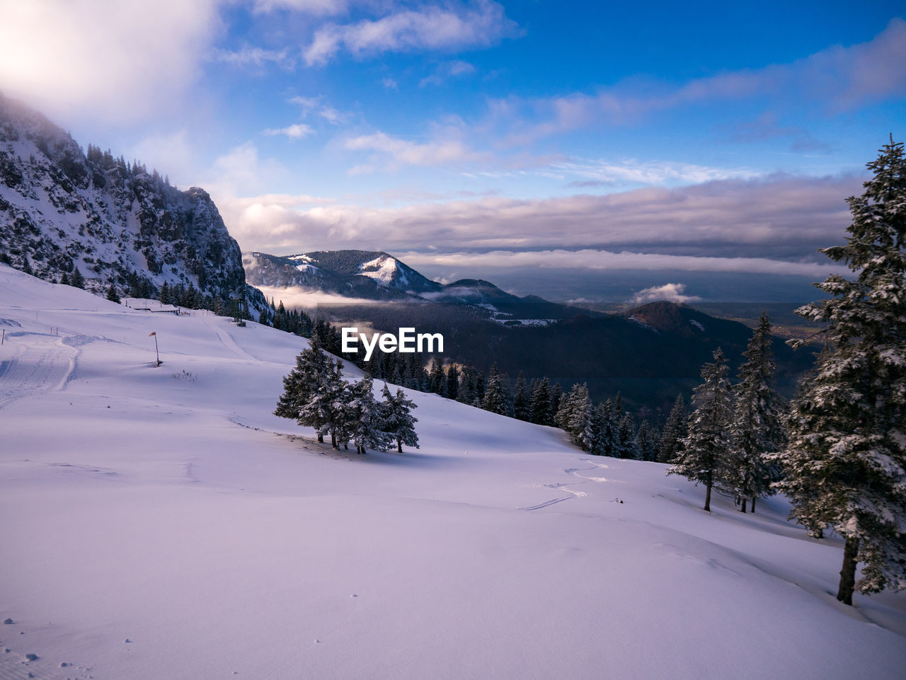 Scenic view of snow covered landscape against sky