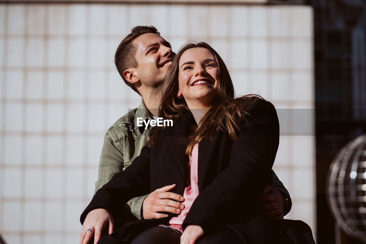 YOUNG COUPLE SITTING ON FLOOR