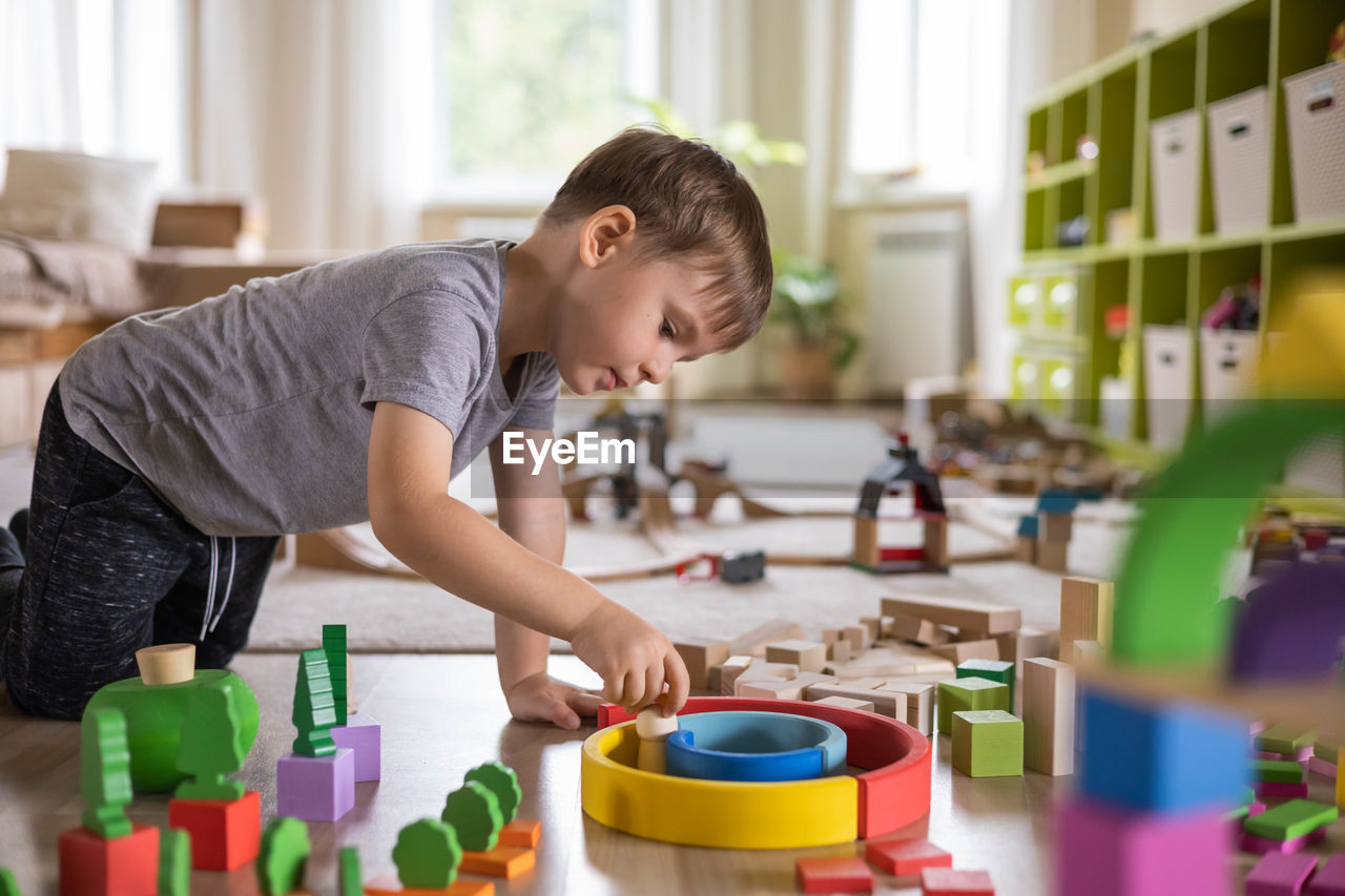 side view of boy painting on table