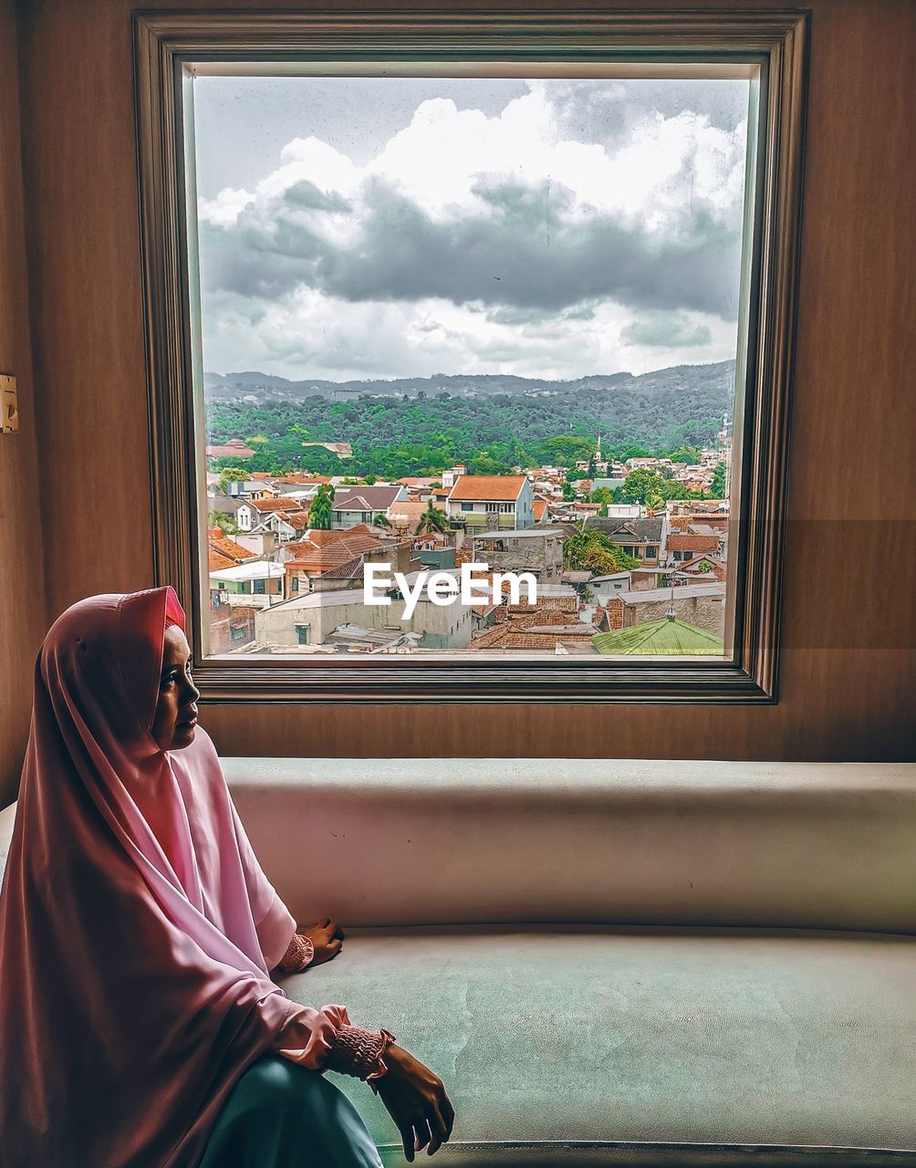 Woman looking through window