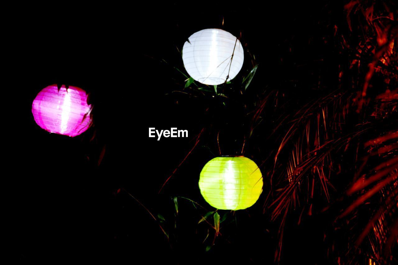 LOW ANGLE VIEW OF ILLUMINATED LIGHTS AT NIGHT