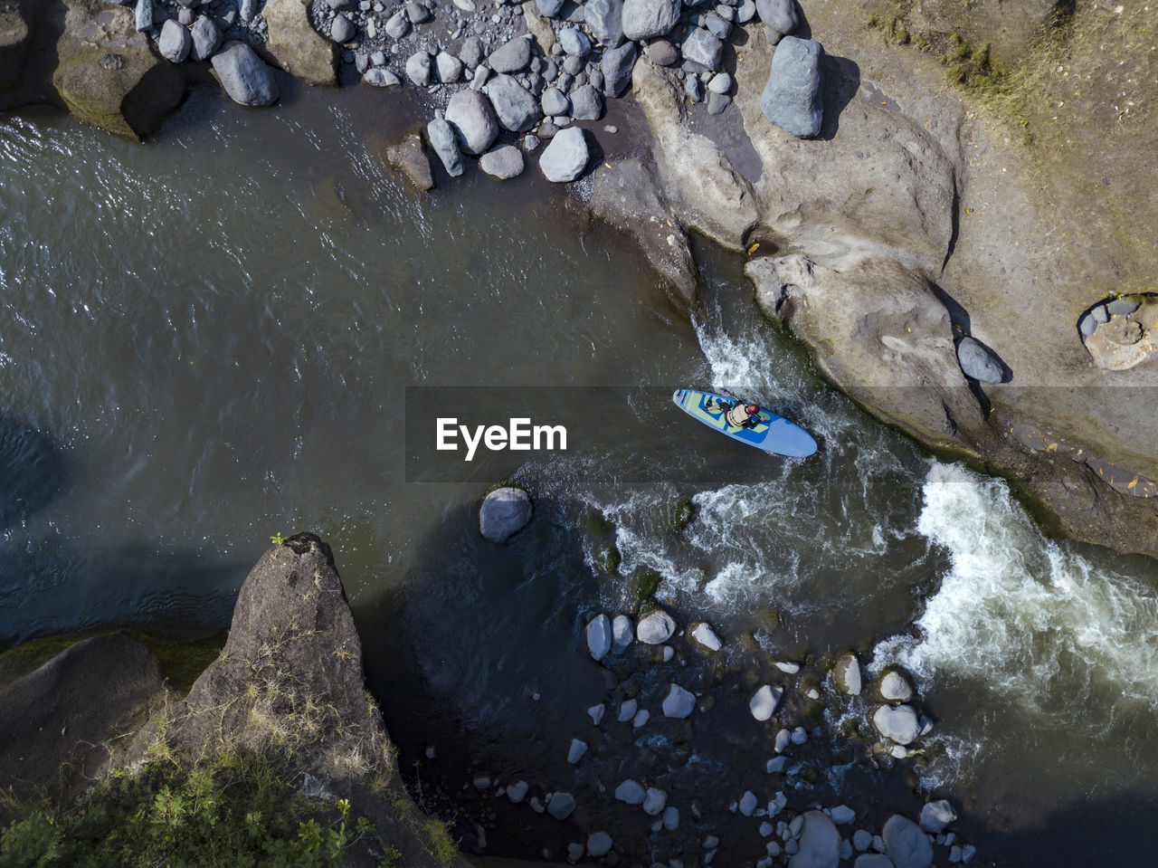 Man paddle boarding the river