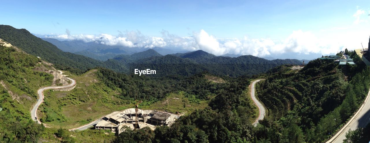 Scenic view of green mountains against sky