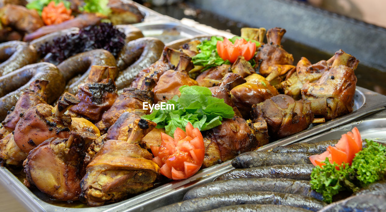 Pig trotters and sausages for sale on street food stall at christmas market in budapest, hungary