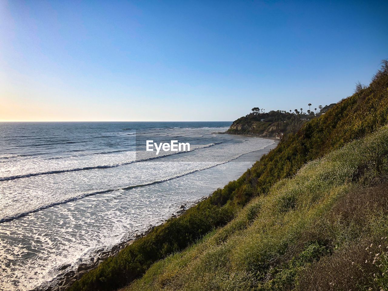 Scenic view of sea against clear blue sky