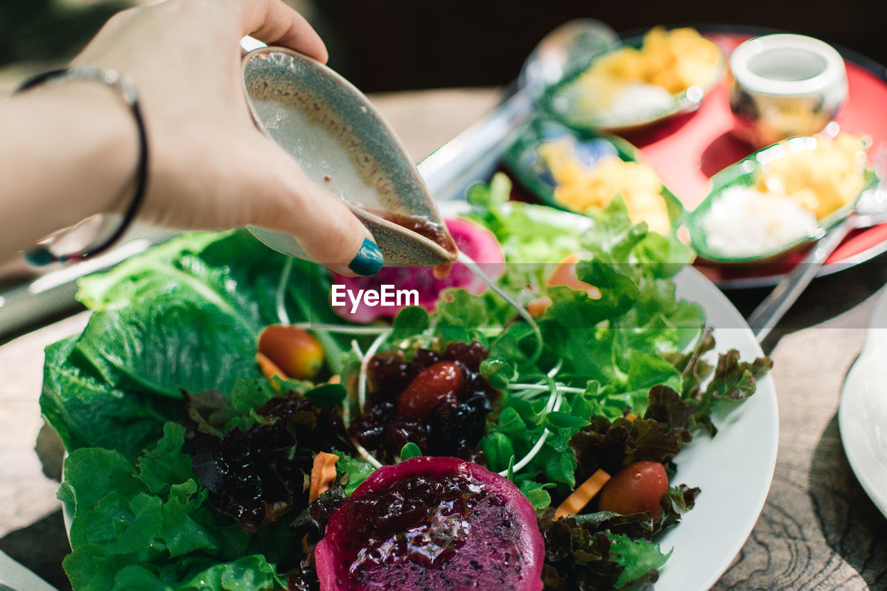 Close-up of hand holding food salad