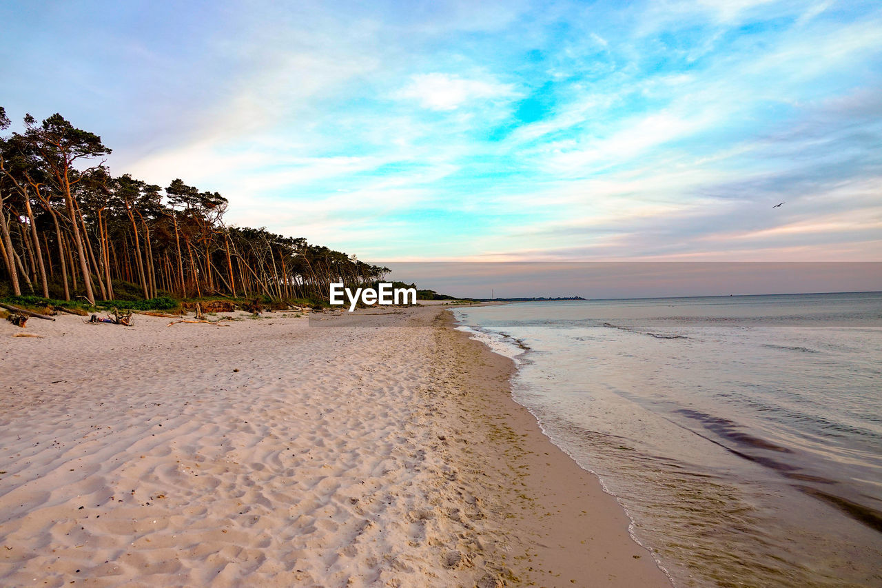 Scenic view of beach against sky during sunset