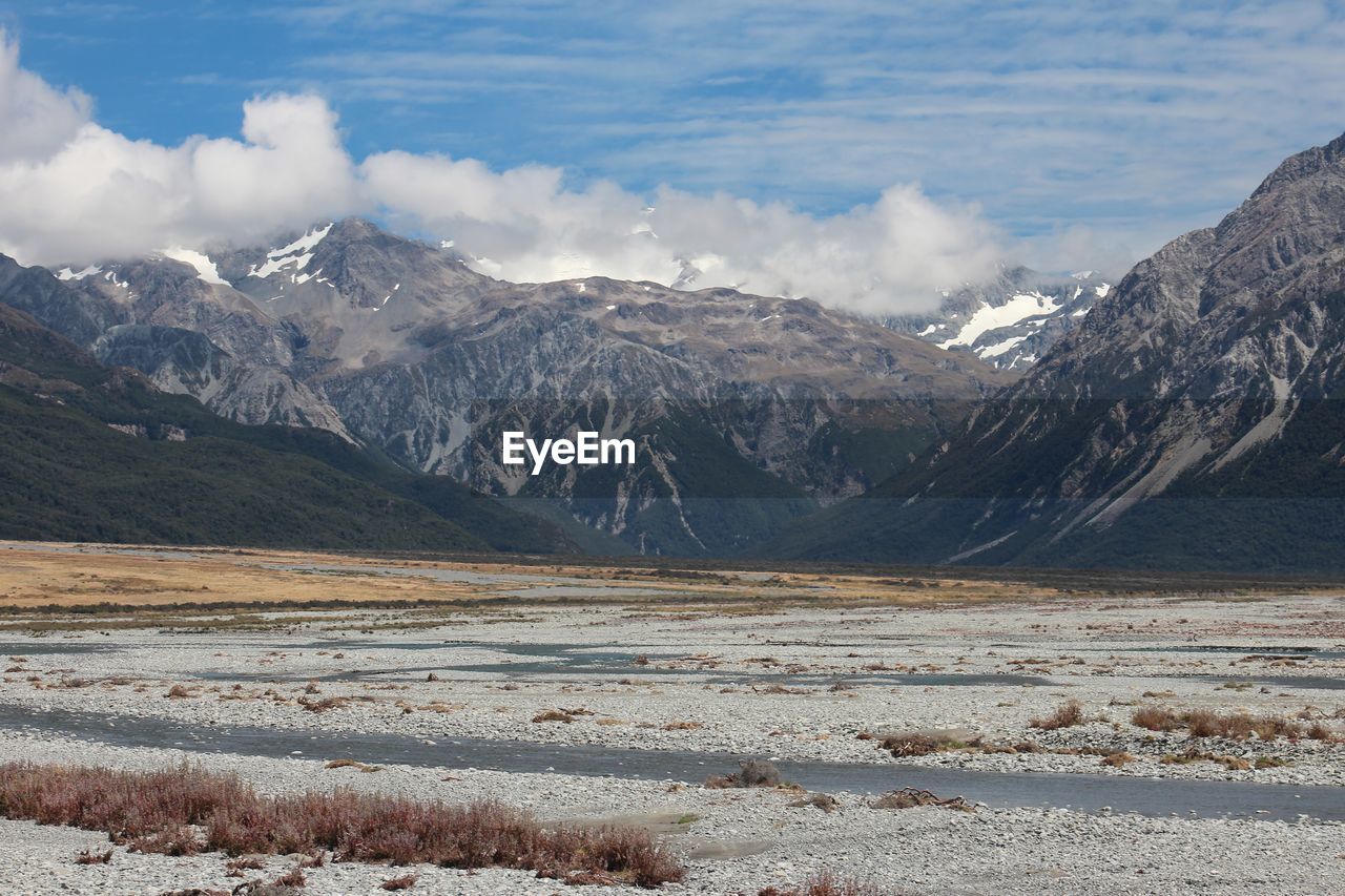 Dry river with mountain range in background