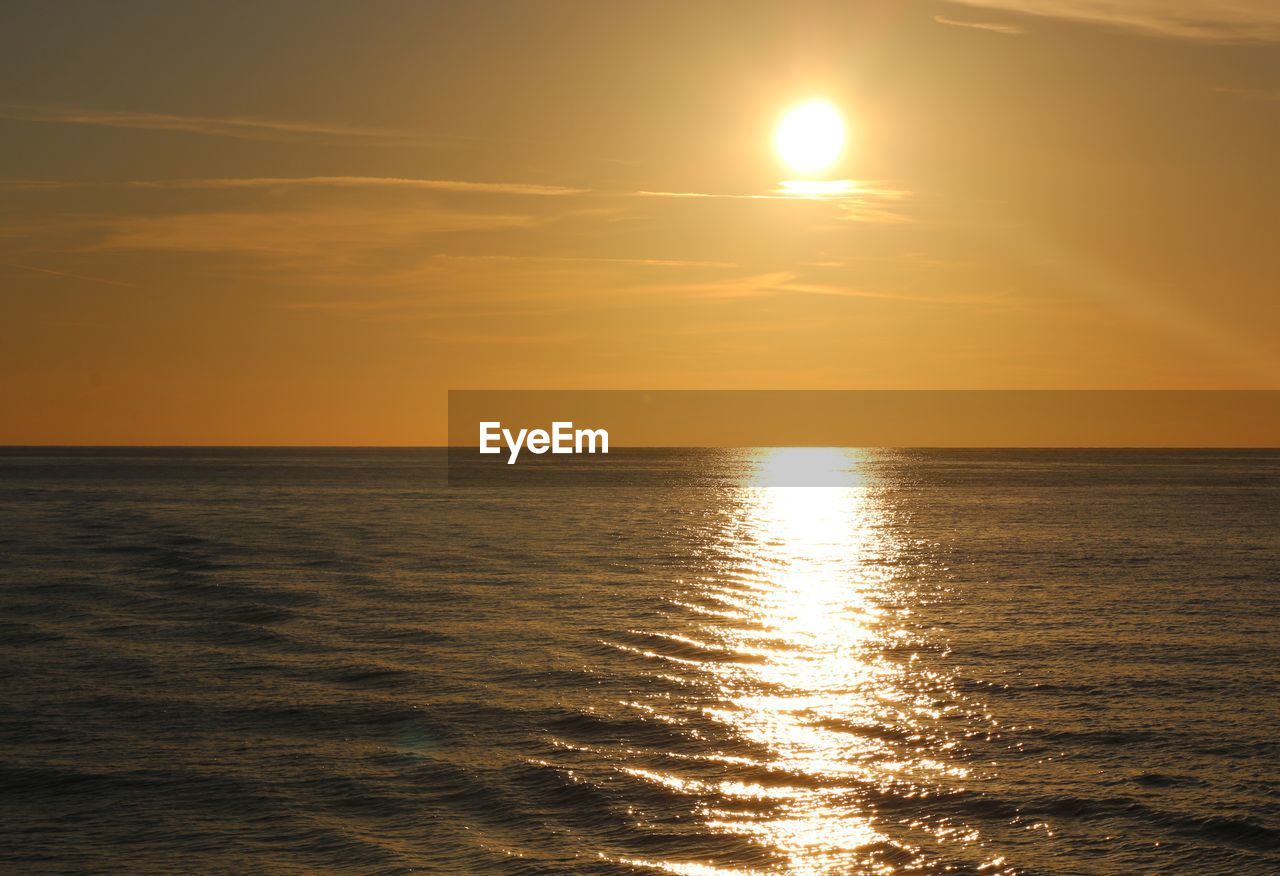water, sky, sea, sunset, beauty in nature, horizon over water, horizon, scenics - nature, tranquility, sun, tranquil scene, sunlight, reflection, idyllic, nature, ocean, afterglow, orange color, seascape, no people, cloud, waterfront, sunbeam, rippled, outdoors, coast, dramatic sky, beach, dawn, non-urban scene, shore, land, wave, urban skyline, evening, astronomical object, body of water