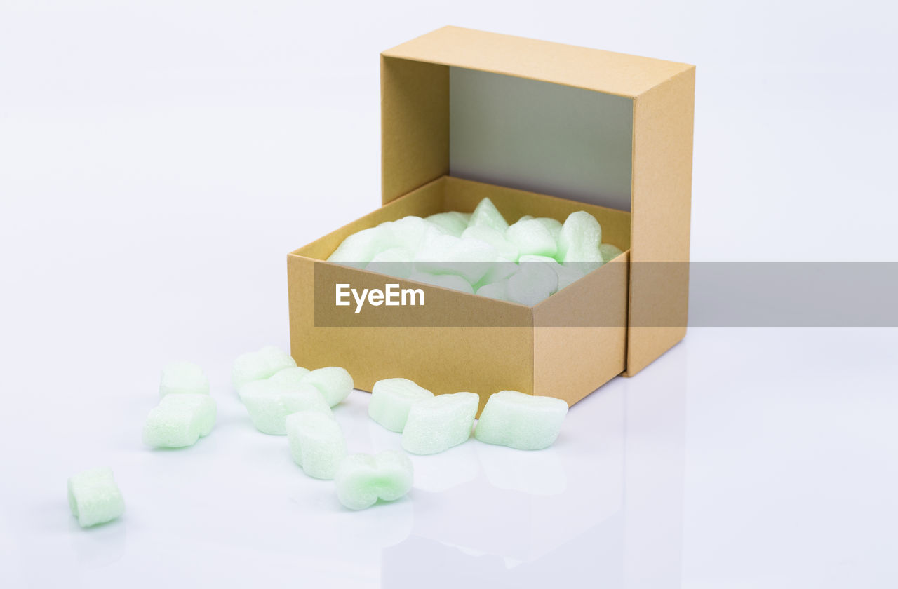 The photo shows an opened package with styrofoam snippets isolated on white background