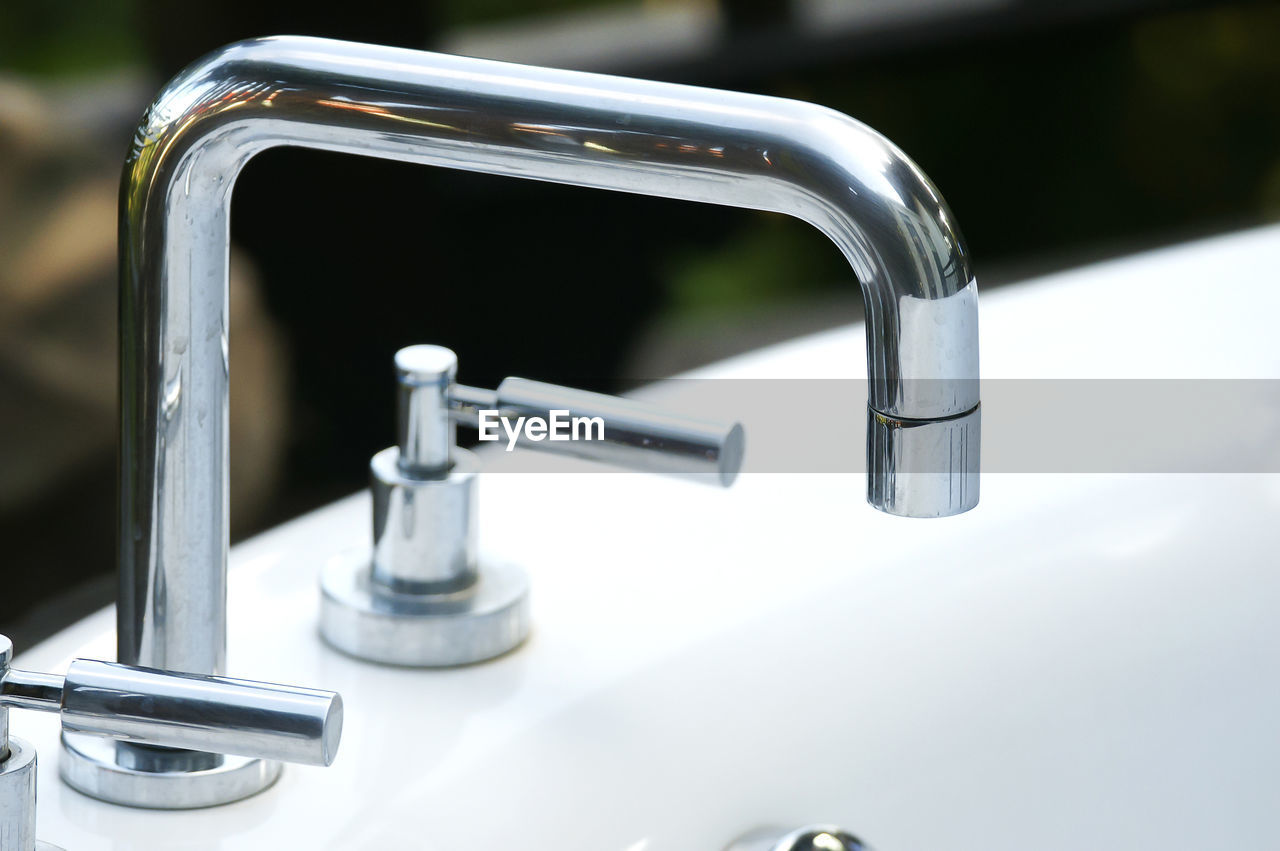 Close-up of faucet in bathroom