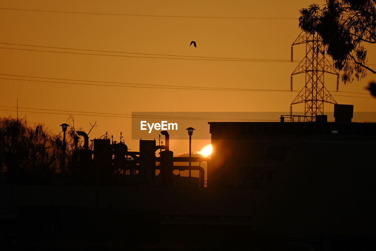 sunset, silhouette, sky, cable, evening, electricity, dusk, power line, technology, sun, nature, electricity pylon, orange color, tree, architecture, light, power supply, power generation, built structure, plant, sunlight, no people, afterglow, electrical supply, outdoors, building exterior, cloud