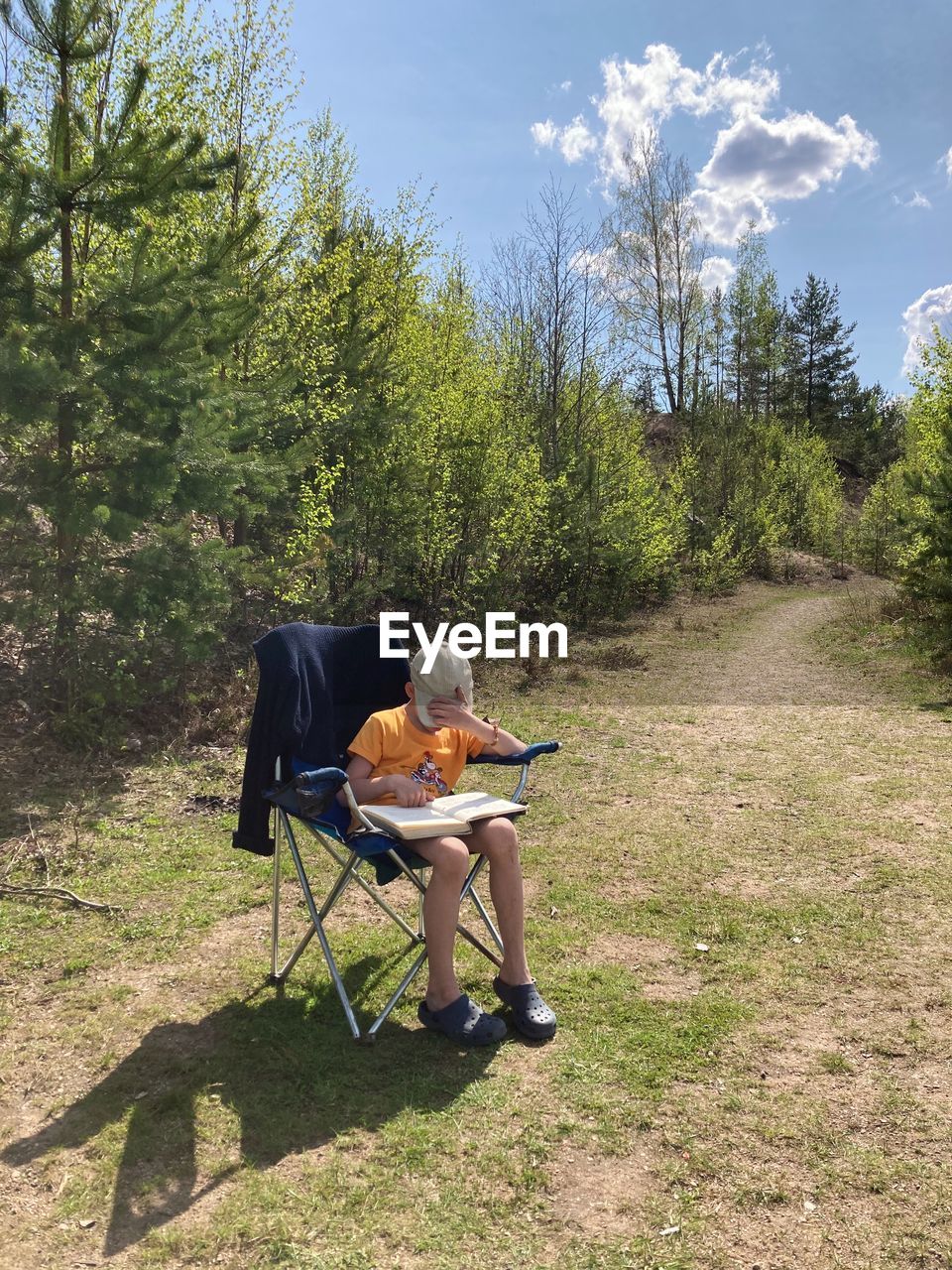 rear view of man sitting on grassy field