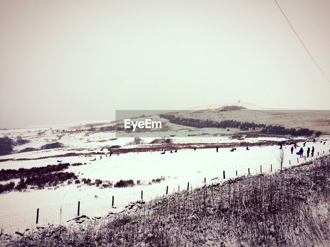 Scenic view of snow covered field against sky