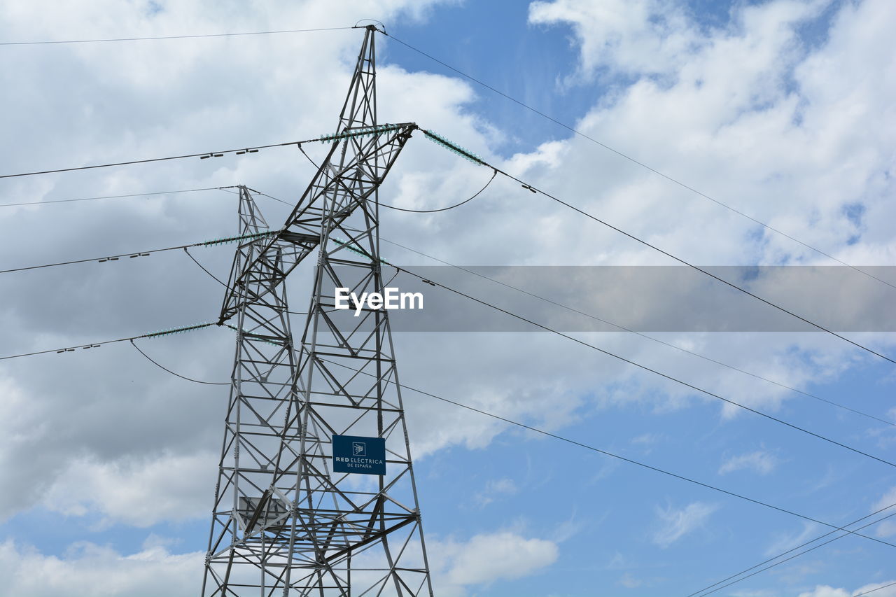 Low angle view of electricity pylon against sky