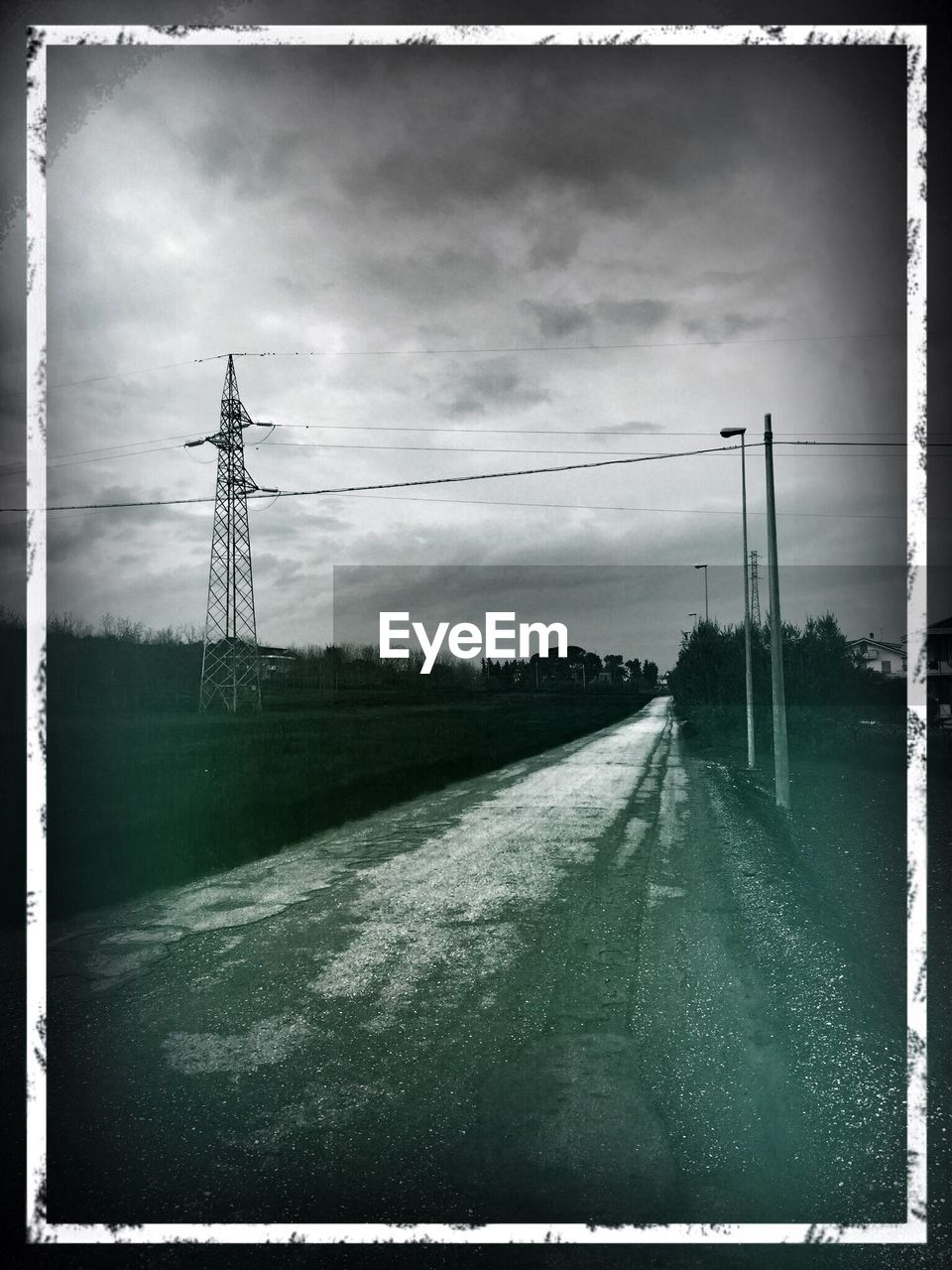 VIEW OF EMPTY ROAD AGAINST CLOUDY SKY