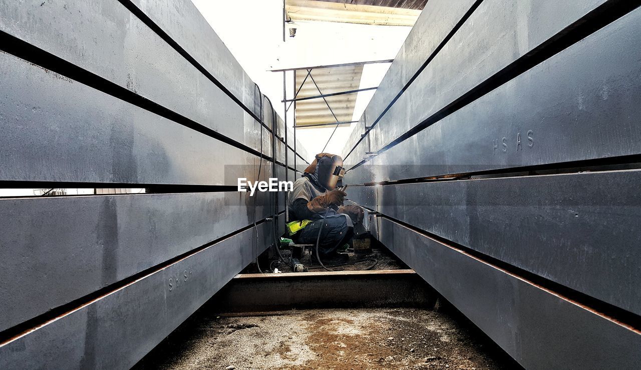 Man working amidst walls