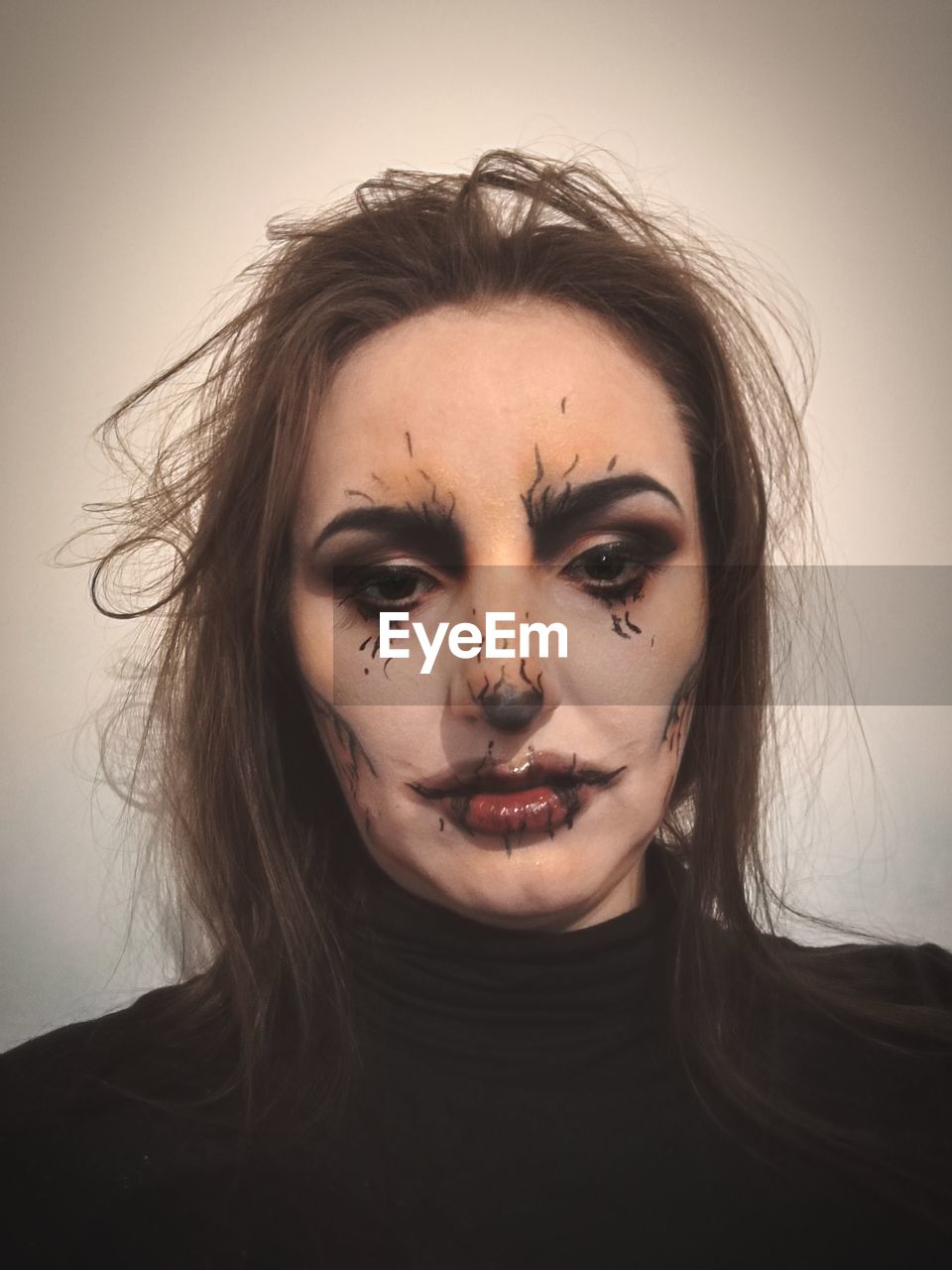 Close-up portrait of young woman with spooky halloween make-up