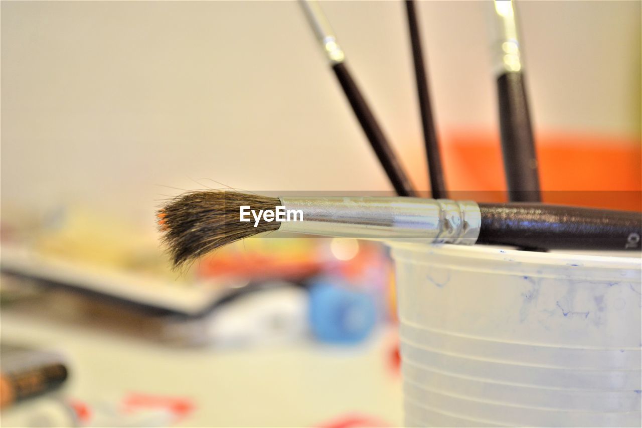 Close-up of paintbrushes on table