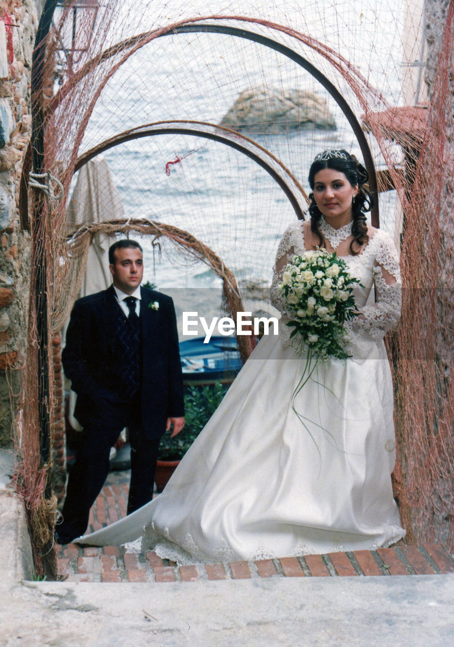 Young bride and groom standing on doorway