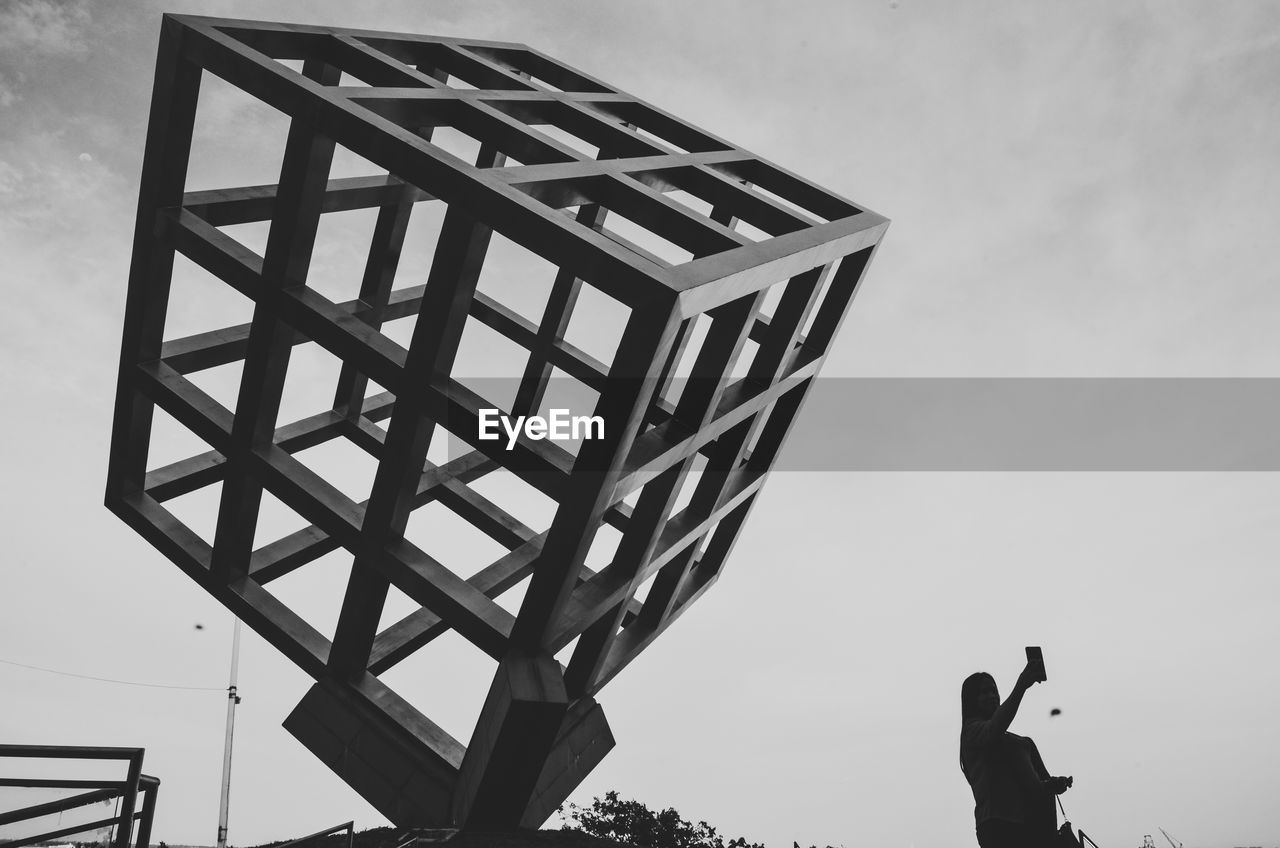 LOW ANGLE VIEW OF MAN AGAINST SKY