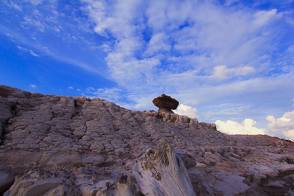 LOW ANGLE VIEW OF ROCKS AGAINST CLOUDY SKY