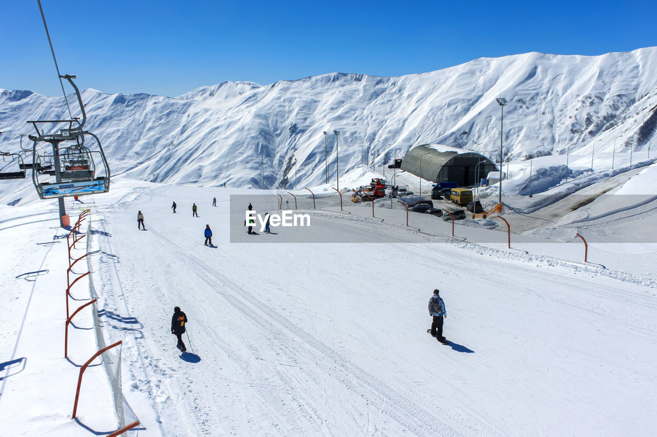 View from the cable car to the ski slope with snowboarders