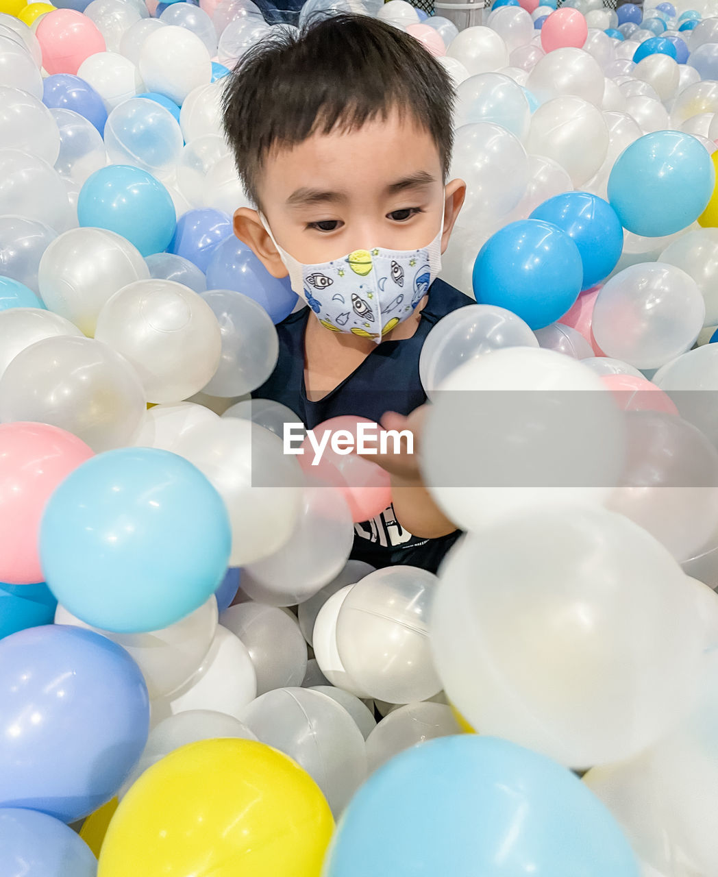 Boy playing with colourful balls