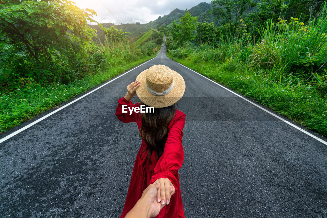 rear view of woman standing against mountain