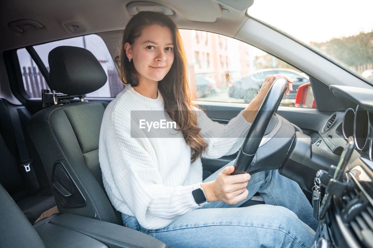 smiling while sitting in car in vehicle