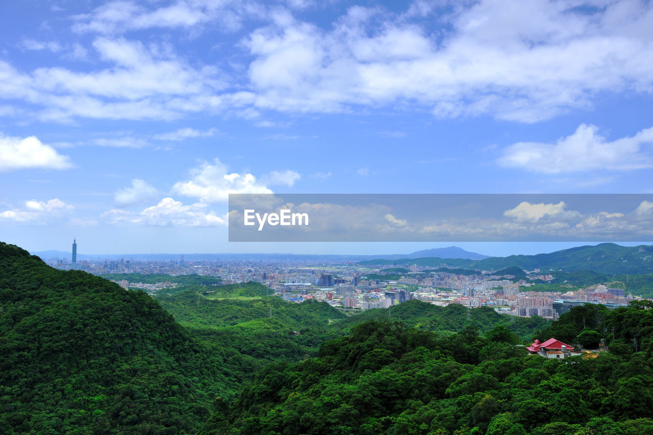 Scenic view of townscape by sea against sky