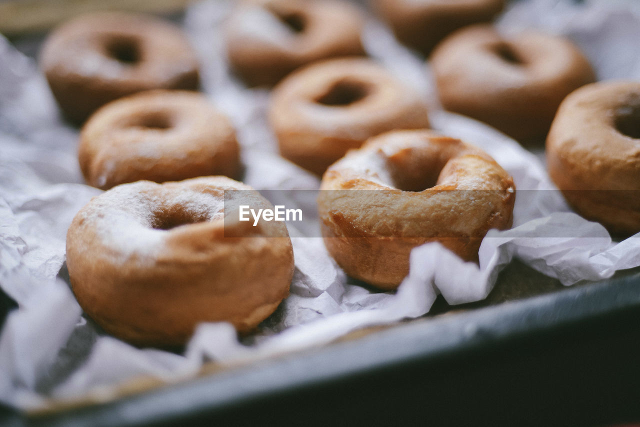 High angle close-up of donuts in tray on table